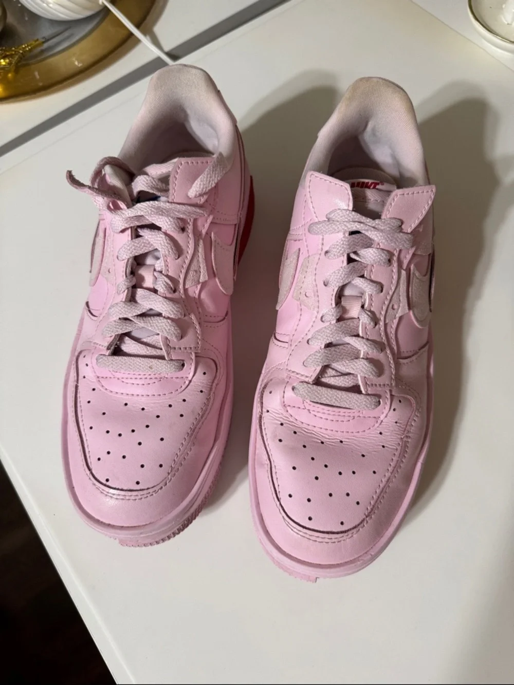 Nike Women’s Pink Low-Top Sneakers with Red Accent
